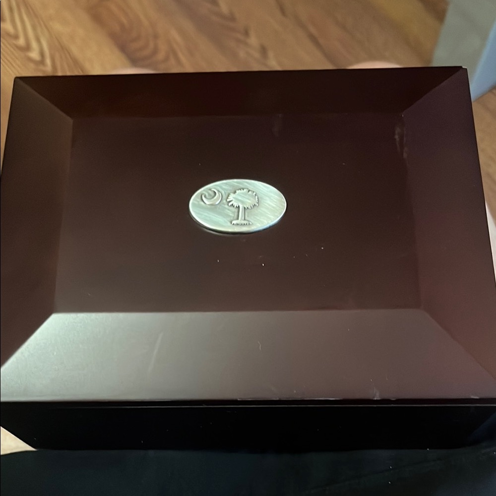 Elegant Brown Jewelry Box with Silver Emblem